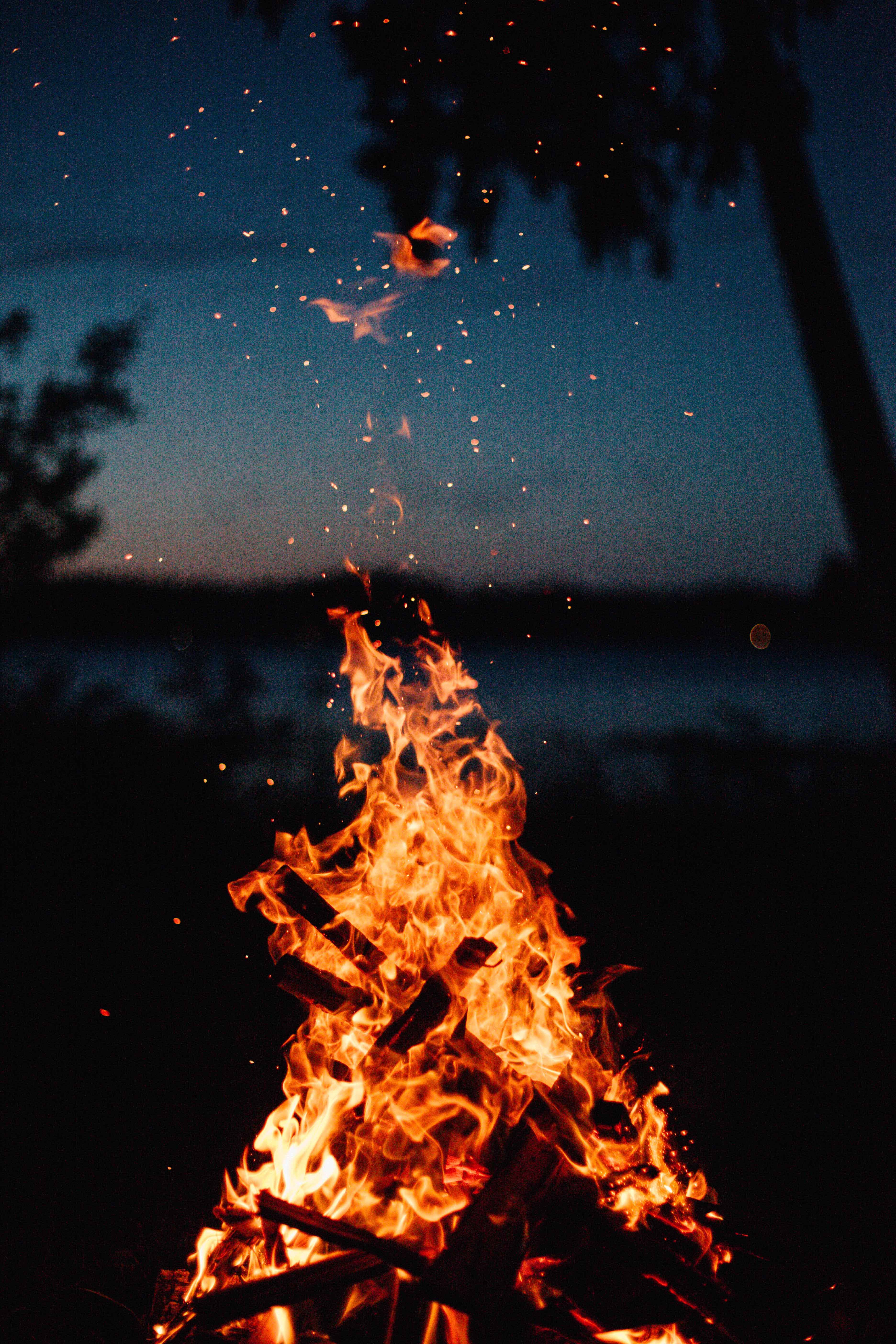Lagerfeuer mit Nachthimmel im Hintergrund